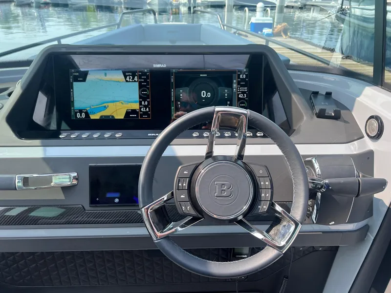 Slide: The Image of 2022 BRABUS Shadow 500 Cabin dashboard with steering wheel and navigation screens. - 15