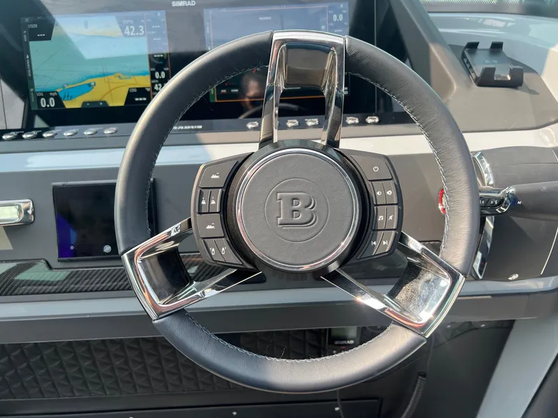 Slide: The Image of Steering wheel of 2022 BRABUS Shadow 500 Cabin with digital displays in background. - 16