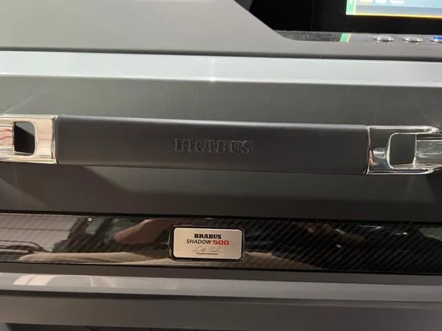 Slide: The Image of 2022 BRABUS Shadow 500 Cabin interior detail with branded handle and nameplate. - 19