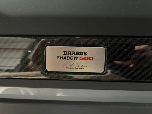Slide: The Image of 2022 BRABUS Shadow 500 Cabin nameplate with carbon fiber detailing. - 20