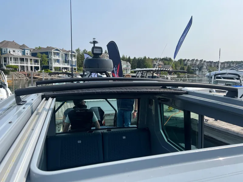 Slide: The Image of 2022 BRABUS Shadow 500 Cabin boat docked at marina with waterfront homes in background. - 26