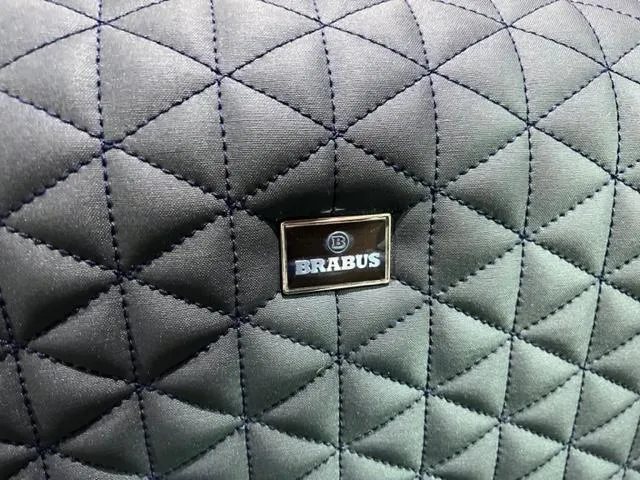Slide: The Image of Quilted interior detail of 2022 BRABUS Shadow 500 Cabin with logo badge. - 29