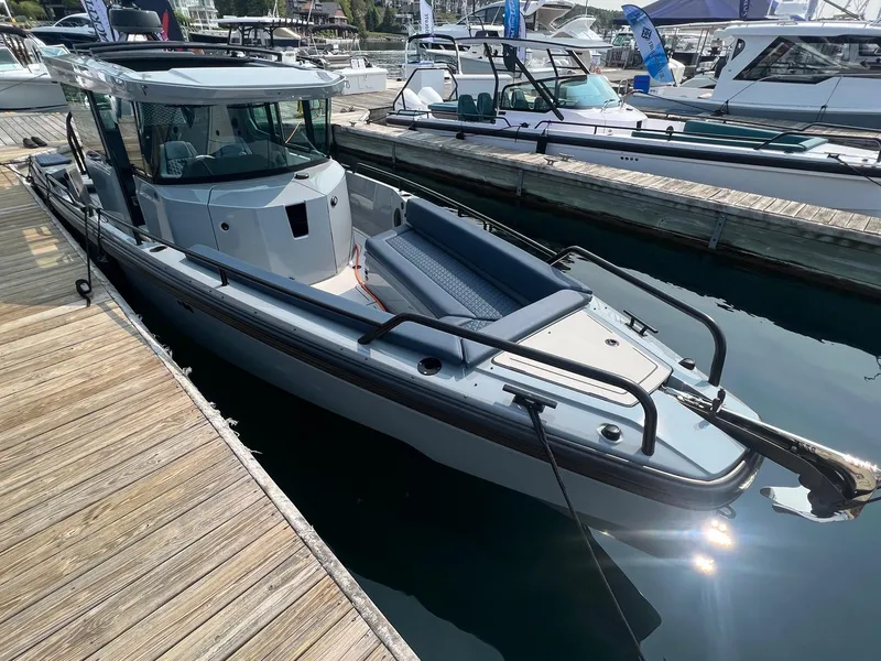 Slide: The Image of 2022 BRABUS Shadow 500 Cabin boat docked at marina, sleek design, luxury features. - 6