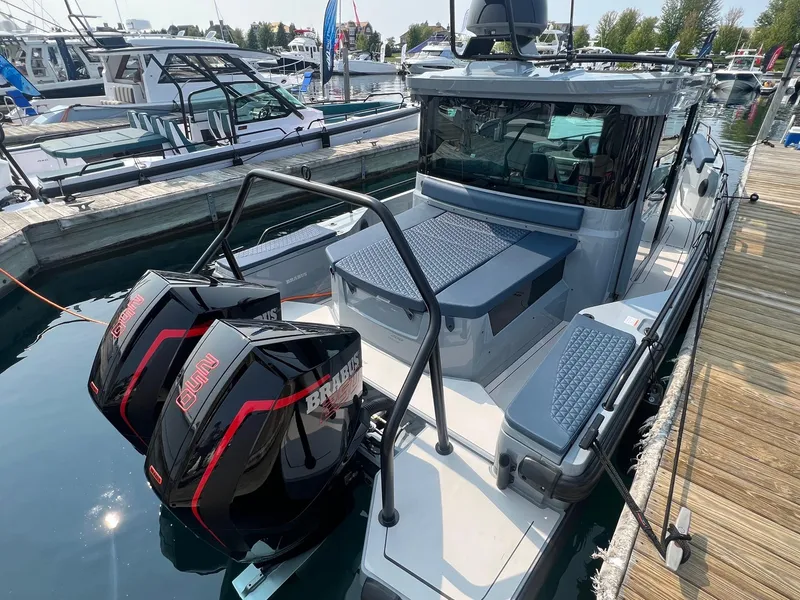 Slide: The Image of 2022 BRABUS Shadow 500 Cabin boat docked with dual outboard engines. - 8