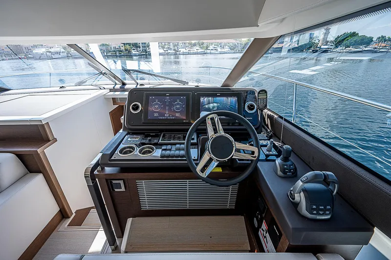 Slide: The Image of Luxurious 2022 Prestige 520 Fly yacht helm with modern navigation systems and waterfront view. - 27
