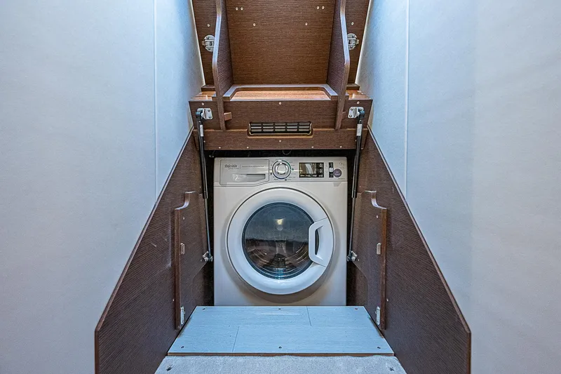 Slide: The Image of Washing machine in 2022 Prestige 520 Fly yacht interior, wooden cabinetry. - 30