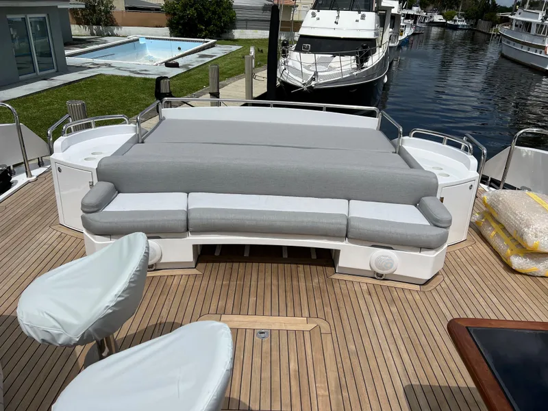 Slide: The Image of Sunseeker Predator 108 2007 yacht deck with cushioned seating and waterfront view. - 14