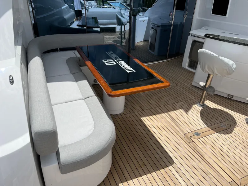 Slide: The Image of 2007 Sunseeker Predator 108 yacht deck with seating and table. - 15
