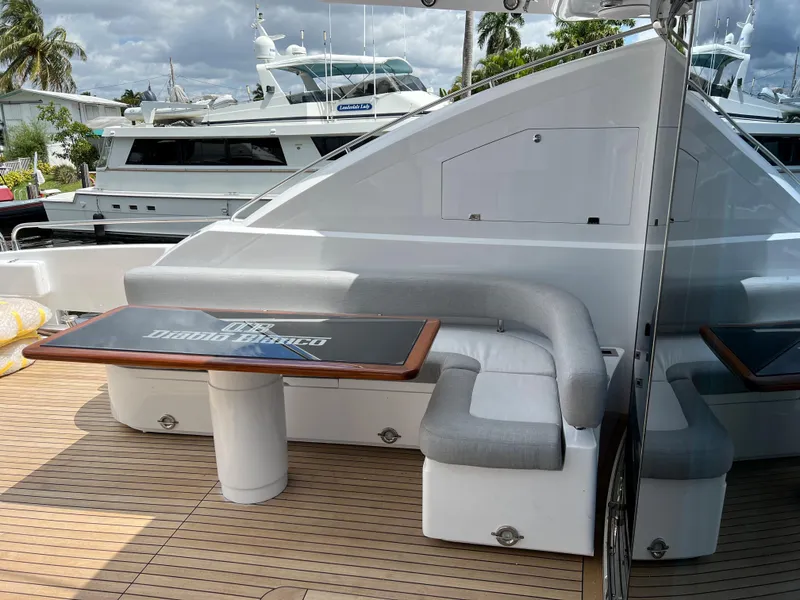 Slide: The Image of Sunseeker Predator 108 yacht 2007, outdoor seating area with table, docked at marina. - 16