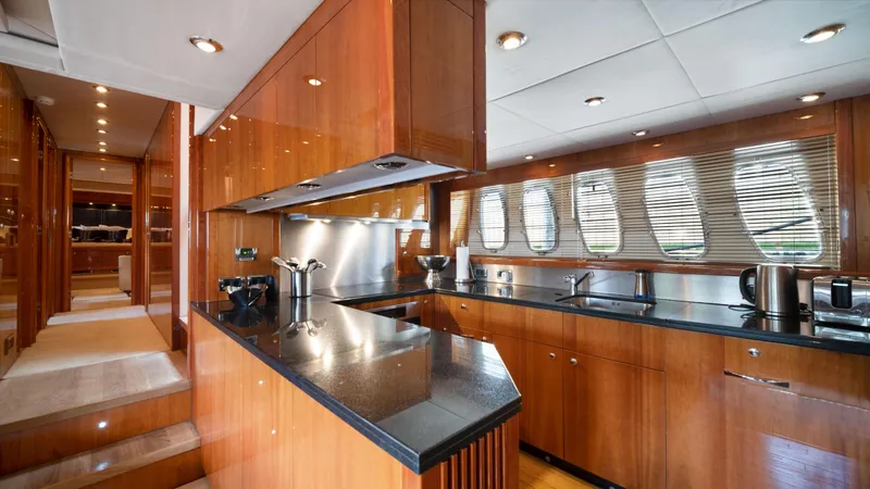 Slide: The Image of Luxurious kitchen interior of 2007 Sunseeker Predator 108 yacht with wooden cabinetry and modern appliances. - 33