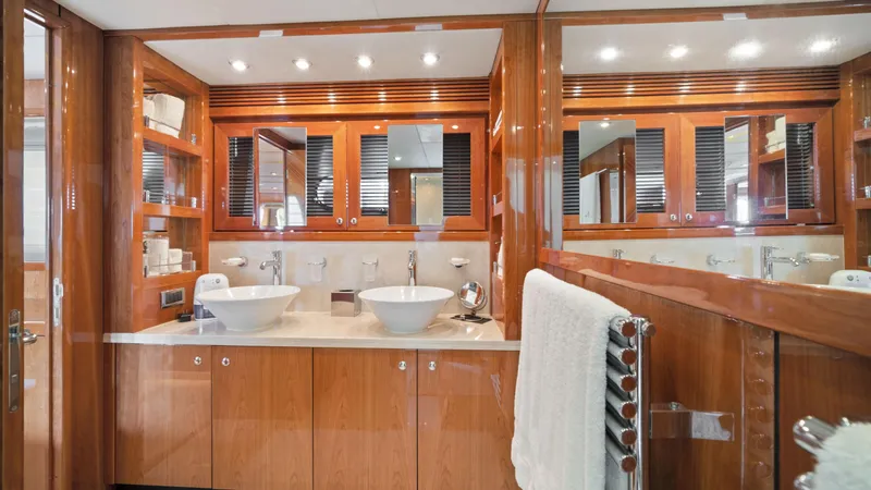 Slide: The Image of Luxurious bathroom in a 2007 Sunseeker Predator 108 yacht with dual sinks and wooden cabinetry. - 48