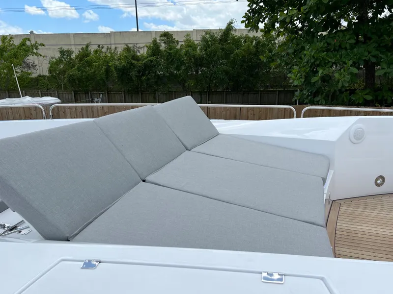 Slide: The Image of Sunseeker Predator 108 2007 yacht with gray cushioned sunbeds on deck. - 5