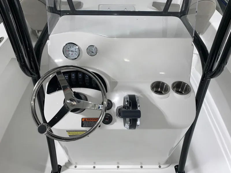 Slide: The Image of 2024 Savannah SS21 boat console with steering wheel, gauges, and cup holders. - 7