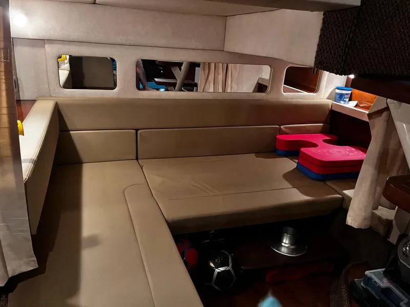 Slide: The Image of Interior of 2012 Sea Ray 350 Sundancer with beige seating and windows. - 20