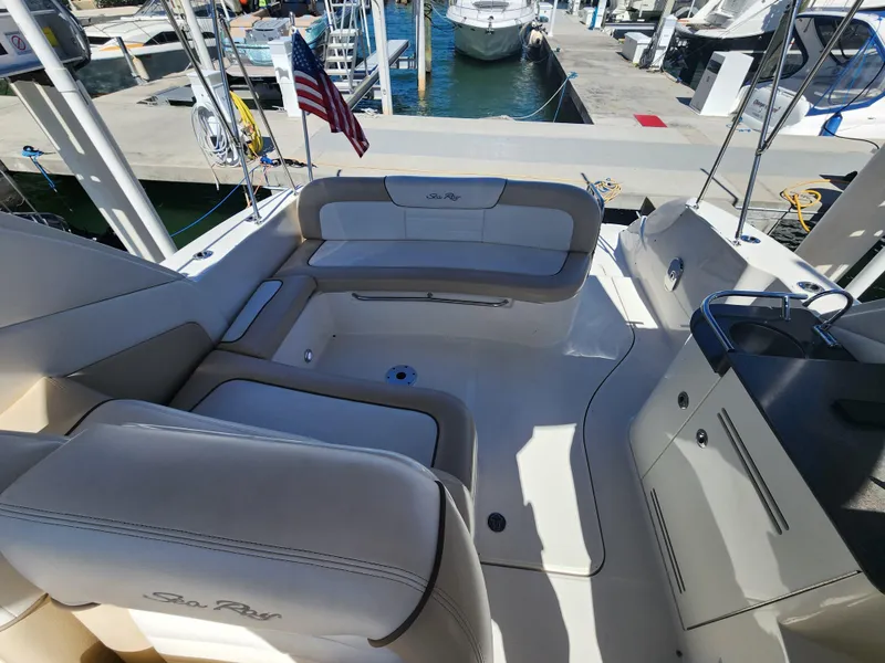 Slide: The Image of 2012 Sea Ray 350 Sundancer boat interior with seating and dock view. - 6