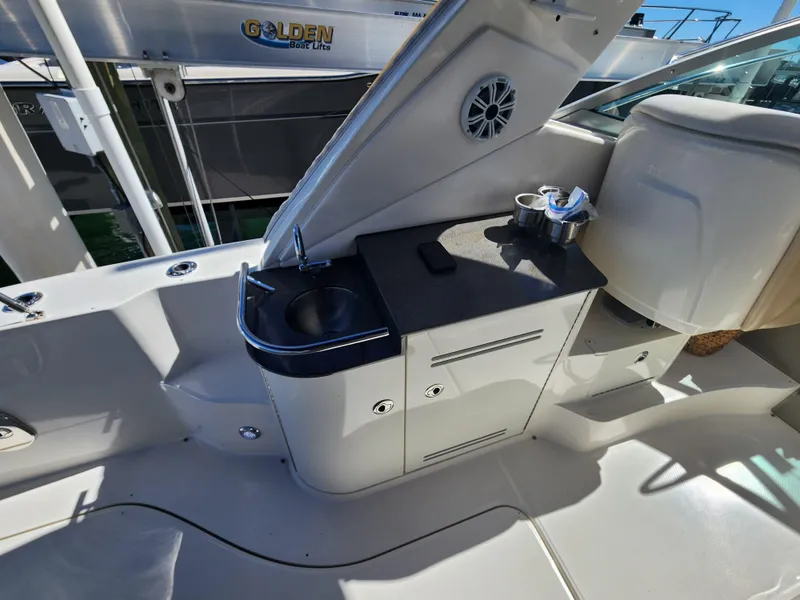 Slide: The Image of 2012 Sea Ray 350 Sundancer boat interior with sink and storage area. - 8
