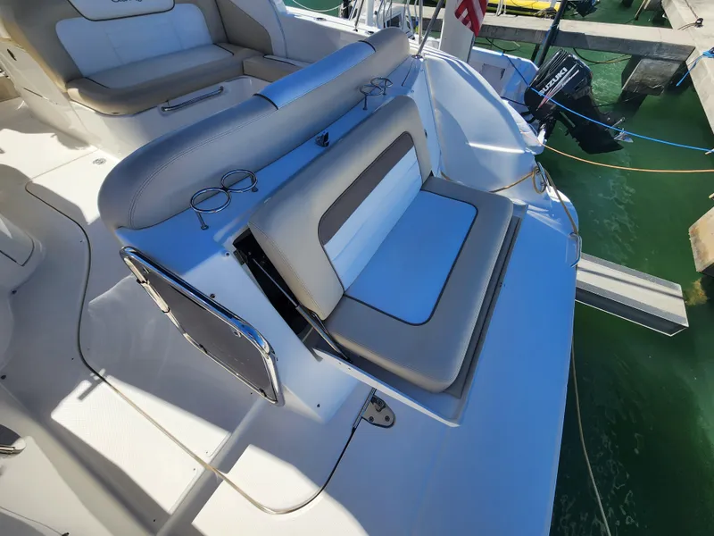 Slide: The Image of 2012 Sea Ray 350 Sundancer boat seating area with beige and white upholstery. - 9