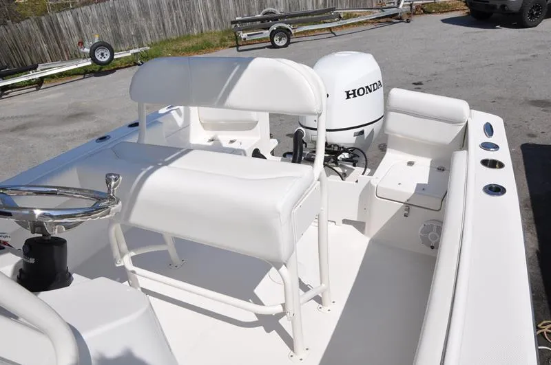 Slide: The Image of 2021 Century Coronado boat with Honda outboard motor, white interior, and seating arrangement. - 12