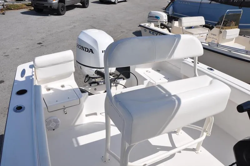 Slide: The Image of 2021 Century Coronado boat with Honda outboard motor and white seating. - 13