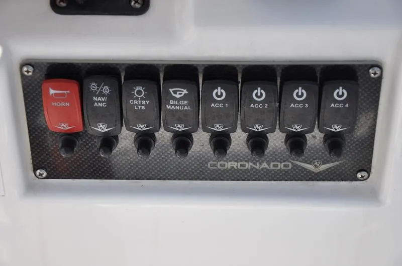 Slide: The Image of Control panel of a 2021 Century Coronado boat with various switches. - 15