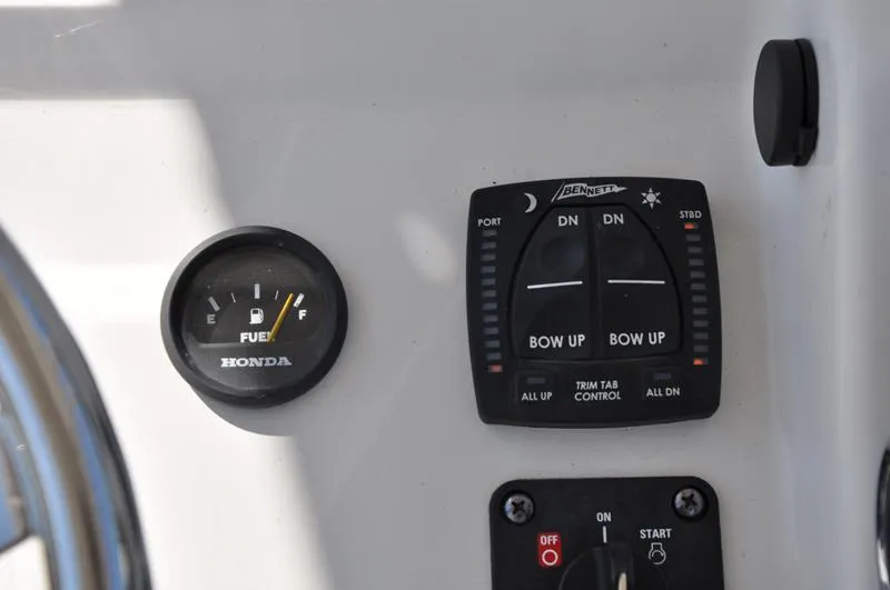 Slide: The Image of 2021 Century Coronado boat dashboard with fuel gauge and trim tab controls. - 16