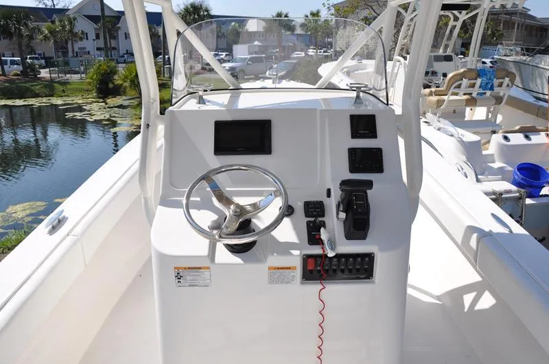 Slide: The Image of 2021 Century Coronado boat helm with steering wheel and control panel. - 7