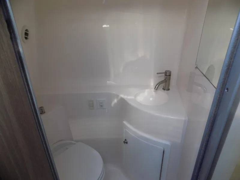 Slide: The Image of Compact bathroom in 2019 Regal 26XO boat with sink and toilet. - 10