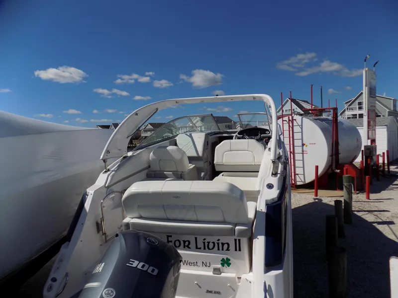 Slide: The Image of 2019 Regal 26XO boat with outboard motor, docked under a clear blue sky. - 12