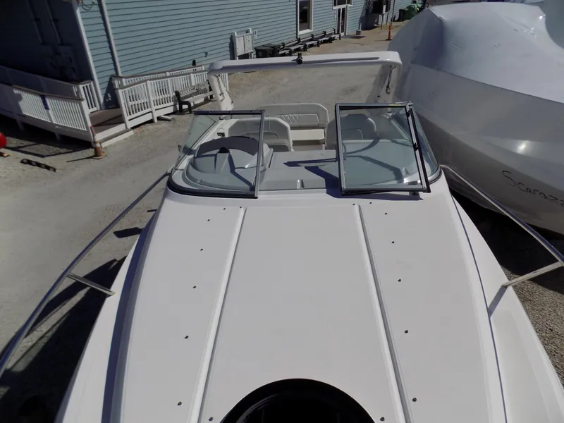 Slide: The Image of 2019 Regal 26XO boat with open cockpit, docked beside a building. - 3