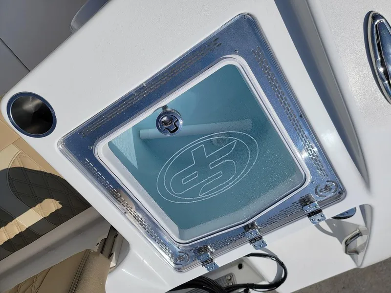 Slide: The Image of 2025 Sea Pro 322 DLX boat compartment with transparent lid and logo. - 12