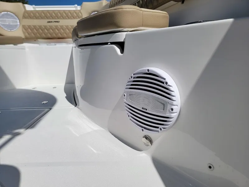 Slide: The Image of 2025 Sea Pro 322 DLX boat interior with speaker and cushioned seating. - 21