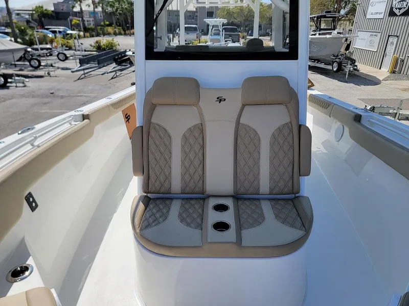Slide: The Image of 2025 Sea Pro 322 DLX boat with dual cushioned seats and cup holders. - 24