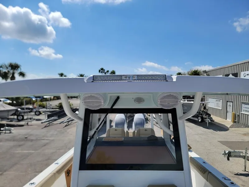 Slide: The Image of 2025 Sea Pro 322 DLX boat with dual engines and T-top in a marina. - 25