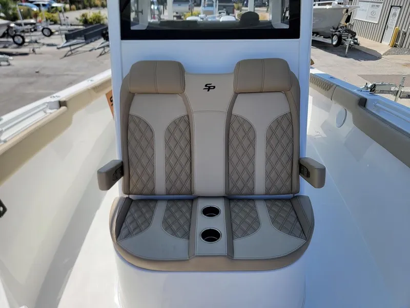Slide: The Image of 2025 Sea Pro 322 DLX boat with dual cushioned seats and cup holders. - 27