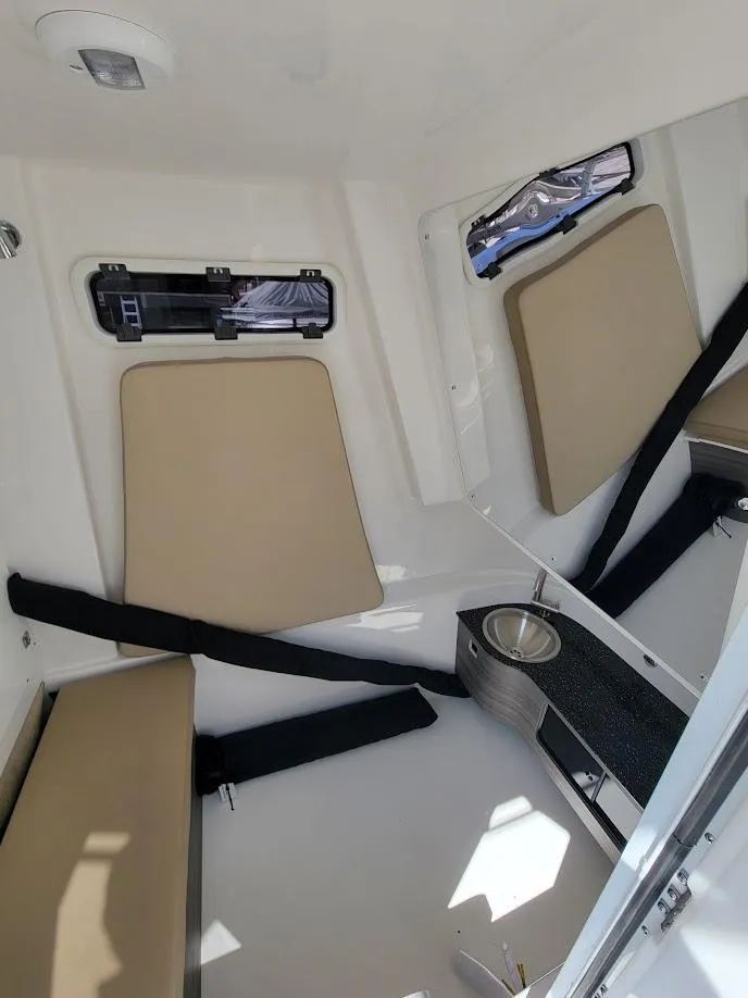 Slide: The Image of Interior cabin of 2025 Sea Pro 322 DLX boat with beige seating. - 30