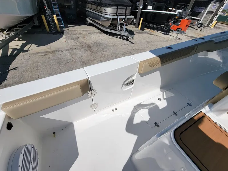 Slide: The Image of 2025 Sea Pro 322 DLX boat interior with beige seating and white deck. - 32