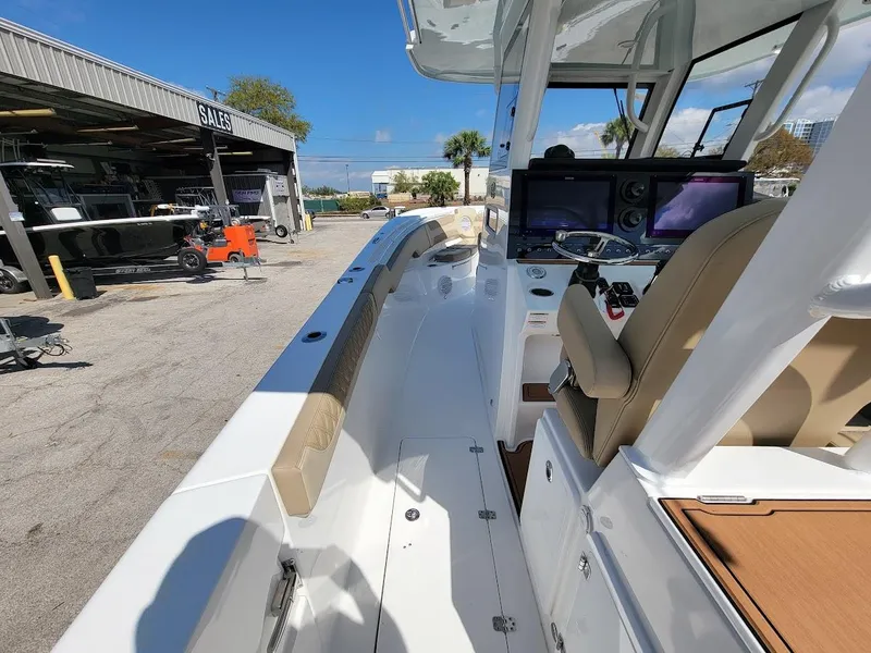 Slide: The Image of 2025 Sea Pro 322 DLX boat interior with helm station and seating. - 33