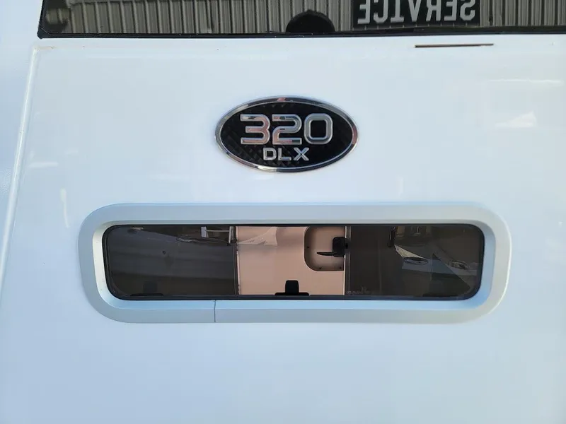 Slide: The Image of 2025 Sea Pro 322 DLX boat rear view with model badge. - 35