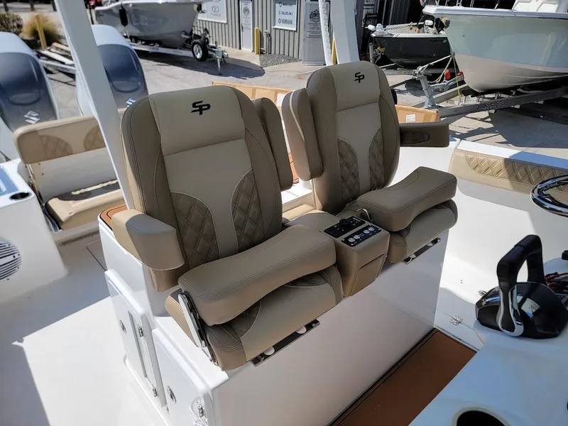 Slide: The Image of 2025 Sea Pro 322 DLX boat with luxurious dual captain's chairs and modern controls. - 8