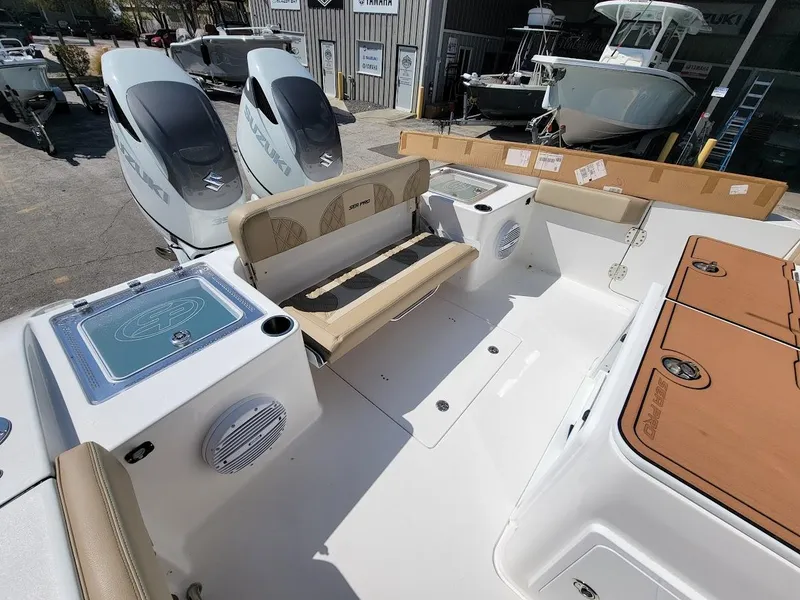 Slide: The Image of 2025 Sea Pro 322 DLX boat interior with seating and twin outboard engines. - 9