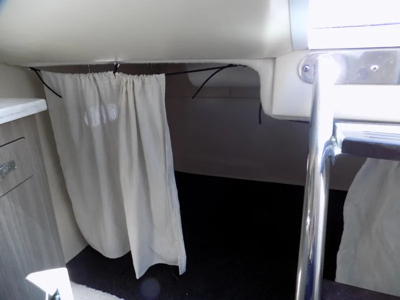 Slide: The Image of Interior cabin of 2019 Regal 26XO boat with curtain and ladder. - 11