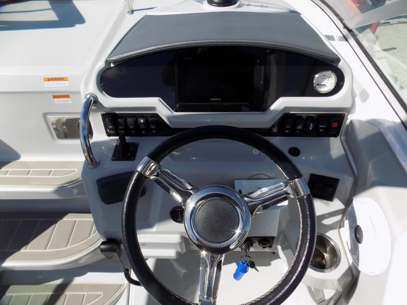 Slide: The Image of Helm of 2019 Regal 26XO boat with steering wheel and control panel. - 7