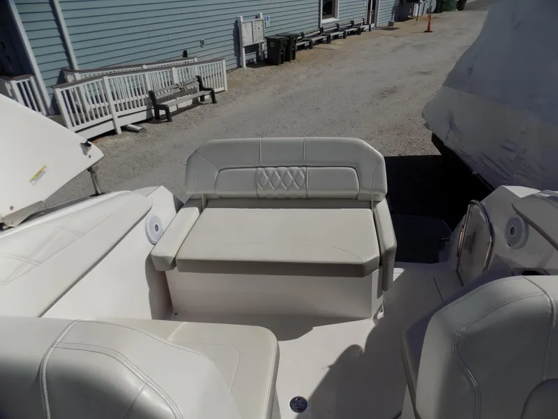 Slide: The Image of 2019 Regal 26XO boat interior with white seating and outdoor setting. - 8