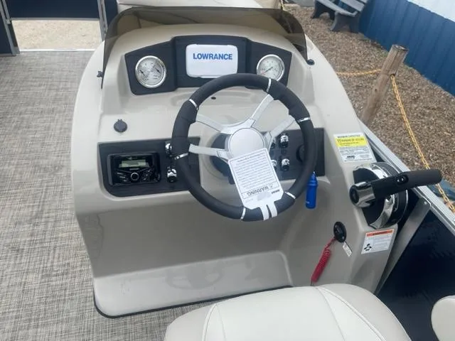 Slide: The Image of 2023 Cypress Cay Seabreeze 212 boat dashboard with Lowrance system and steering wheel. - 10