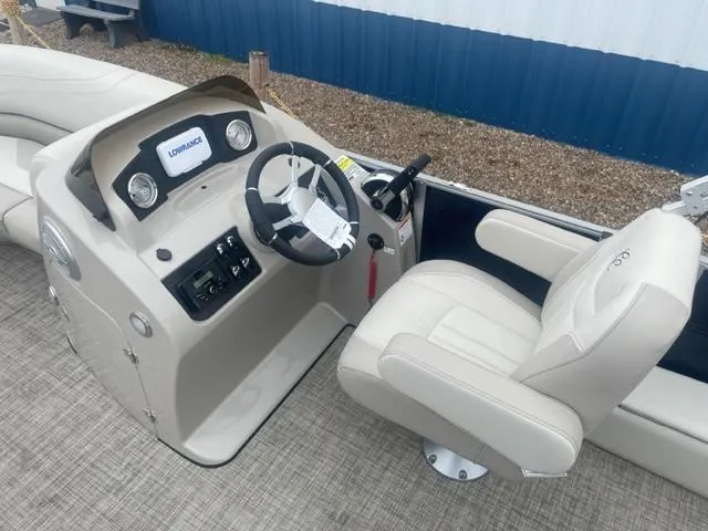 Slide: The Image of 2023 Cypress Cay Seabreeze 212 boat helm with steering wheel and captain's chair. - 11