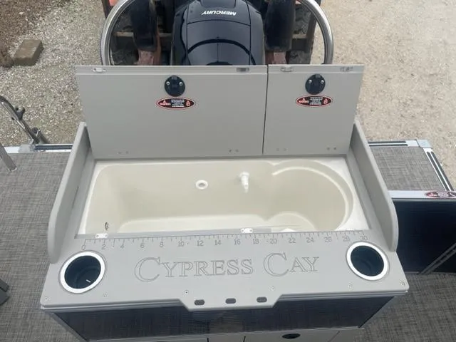 Slide: The Image of 2023 Cypress Cay Seabreeze 212 boat sink and storage area with Mercury engine. - 7