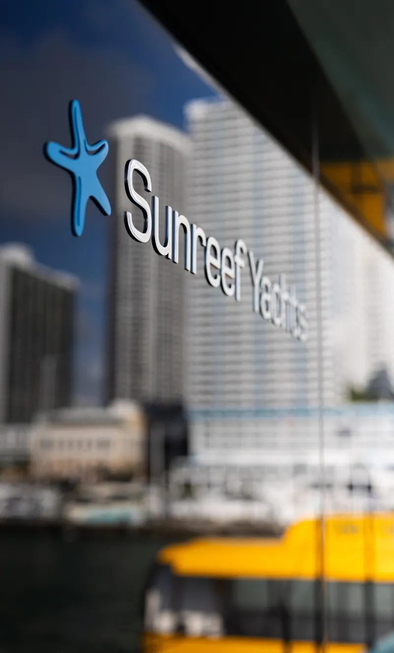 Slide: The Image of Sunreef Yachts logo on glass with cityscape reflection, 2018 Sunreef 68 Supreme. - 1