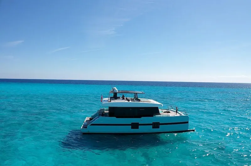 Slide: The Image of Sunreef 68 Supreme yacht cruising on clear blue ocean, 2018 model. - 12