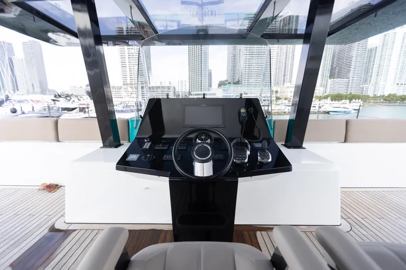 Slide: The Image of Helm of 2018 Sunreef 68 Supreme yacht with city skyline in background. - 15