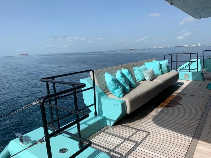 Slide: The Image of Luxurious Sunreef 68 Supreme yacht deck with turquoise cushions, ocean view, 2018 model. - 21
